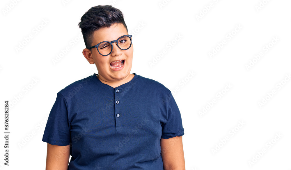 Fototapeta premium Little boy kid wearing casual clothes and glasses winking looking at the camera with sexy expression, cheerful and happy face.