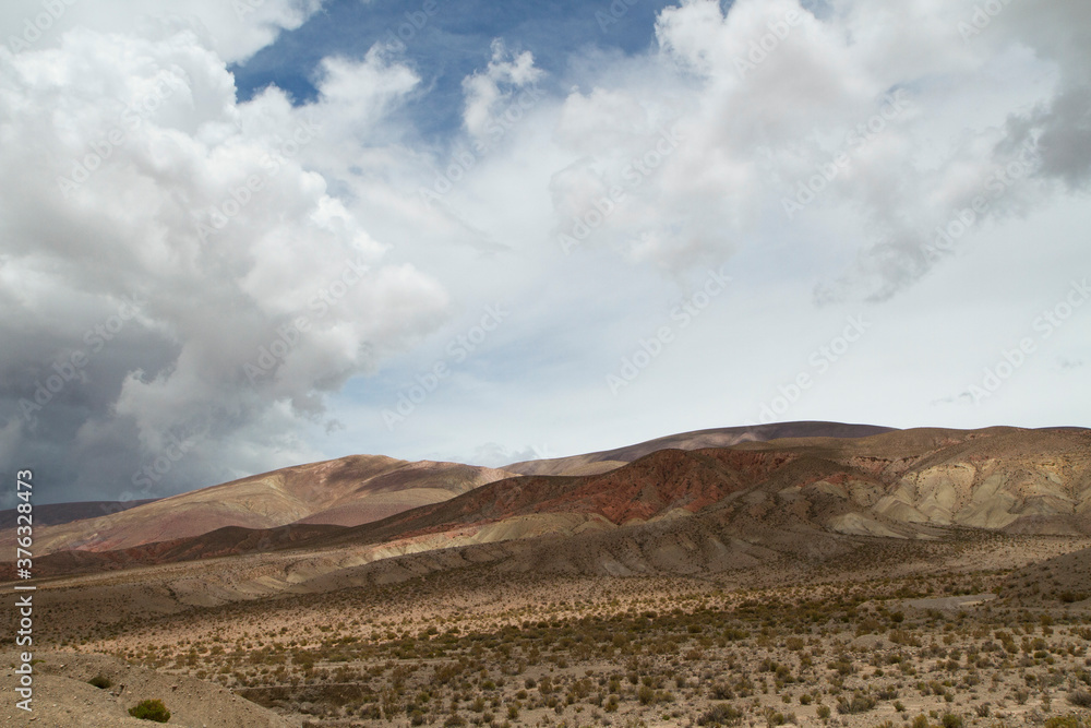 Desert landscape. Majestic view of the arid valley and mountains under a beautiful cloudy sky.