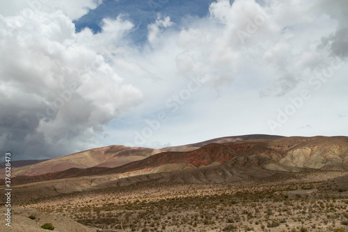 Desert landscape. Majestic view of the arid valley and mountains under a beautiful cloudy sky.