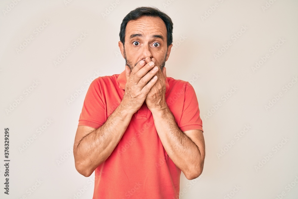 Middle age hispanic man wearing casual clothes shocked covering mouth with hands for mistake. secret concept. Middle age hispanic man wearing casual clothes shocked covering mouth with hands for mistake. secret concept.