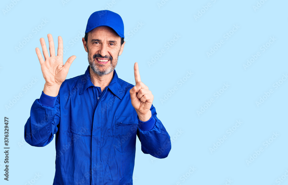 Middle age handsome man wearing mechanic uniform showing and pointing up with fingers number six while smiling confident and happy.