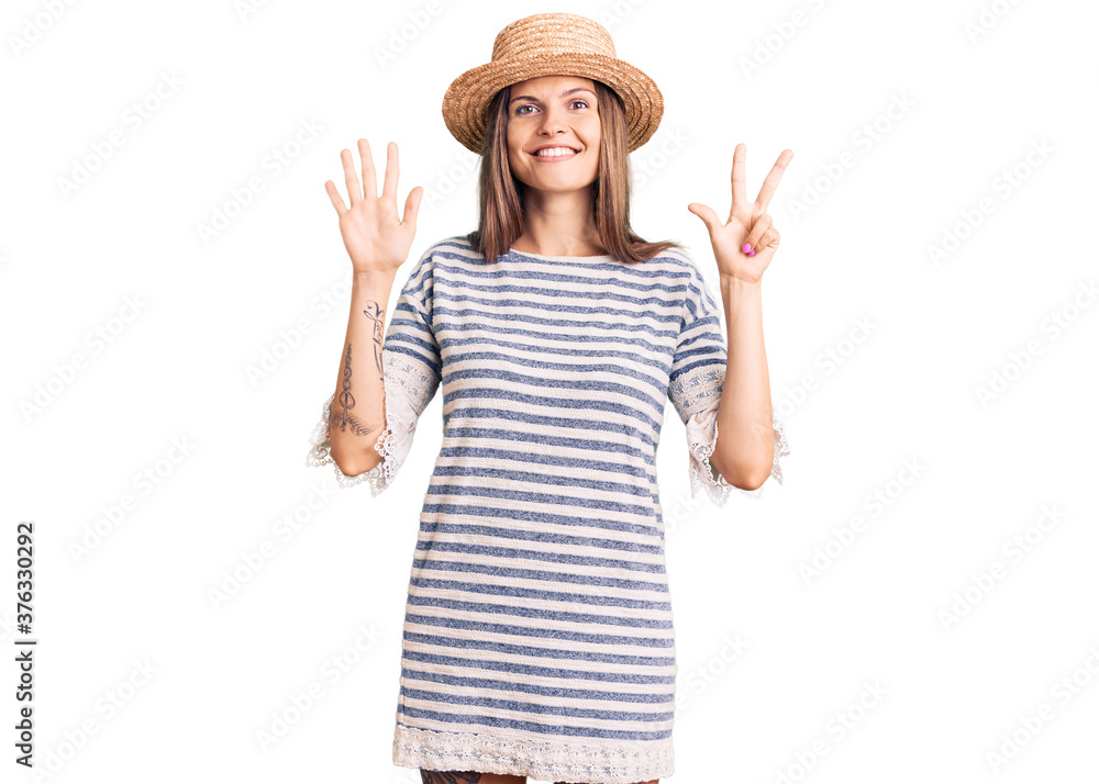 Beautiful caucasian woman wearing summer hat showing and pointing up with fingers number eight while smiling confident and happy. Beautiful caucasian woman wearing summer hat showing and pointing up with fingers number eight while smiling confident and happy.