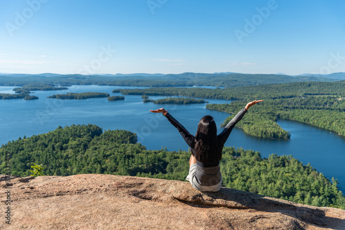 Woman enjoying the view of Squam lake from West Rattlesnake Mountain New Hampshire