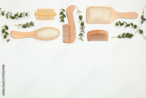 Flat lay composition with modern hair combs and brushes on white background. Space for text