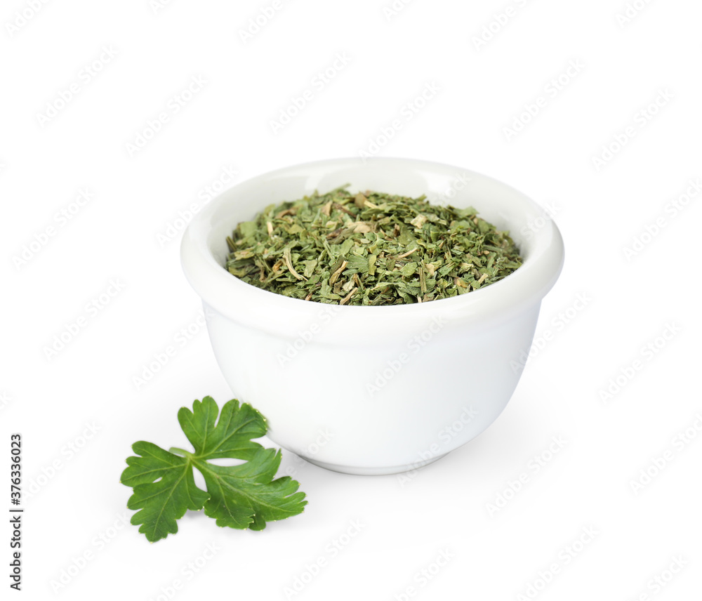 Dry parsley in ceramic bowl on white background Dry parsley in ceramic bowl on white background