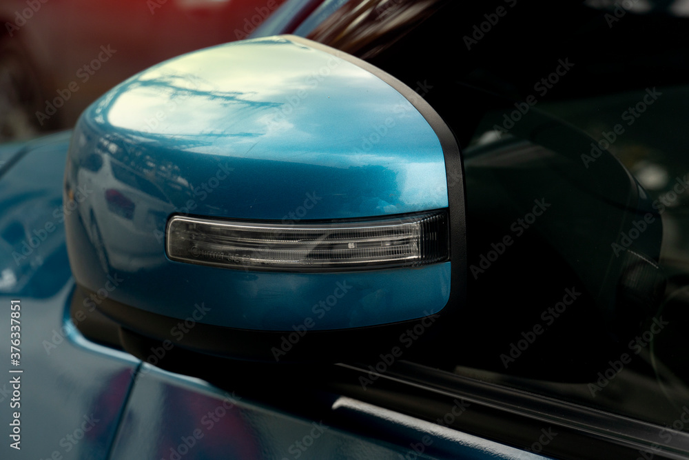 Luxury of blue car side mirror that was folded down while parking. Luxury of blue car side mirror that was folded down while parking.