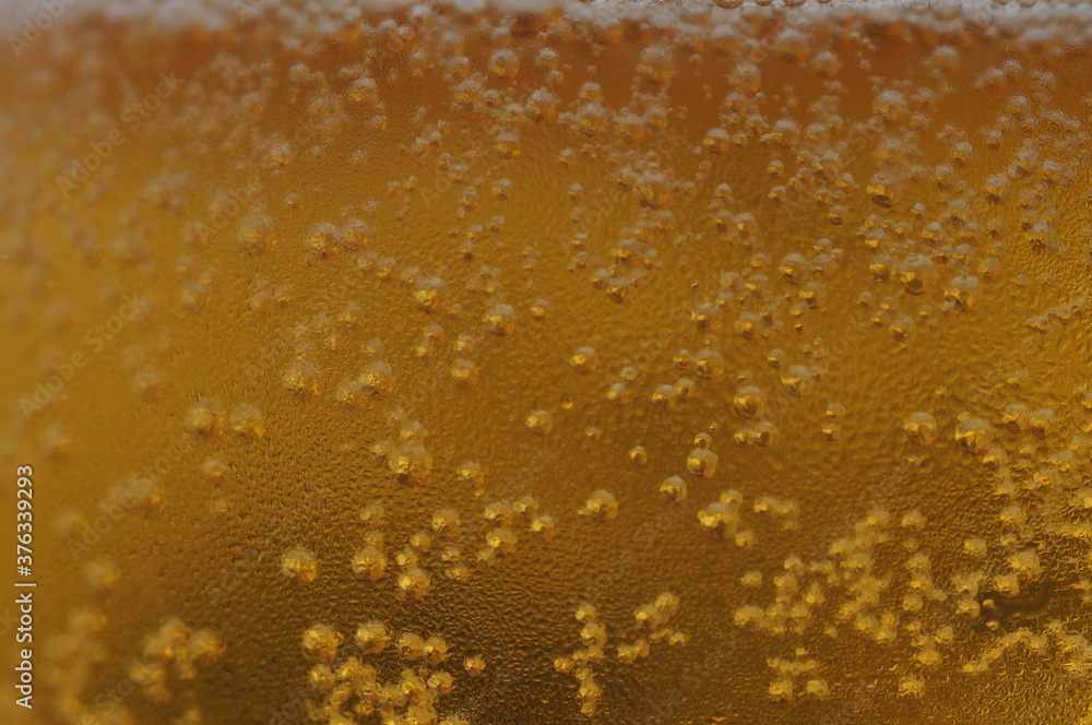 Wet glass of beer, golden color in the dark - obrazy, fototapety, plakaty 