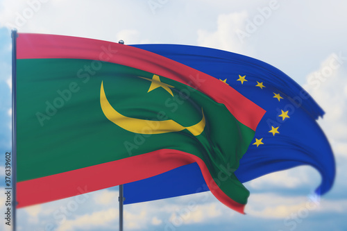 Waving European Union flag and flag of Mauritania. Closeup view, 3D illustration. photo