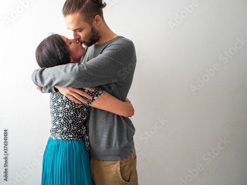 Caucasian Hispanic Couple Kisses and Hugs with Much Love and Affection