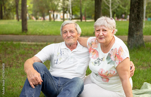 Caucasian elderly couples sit and relax together in the park