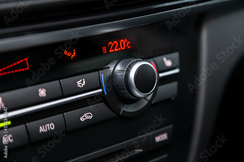 Black  detail with the air conditioning button inside a car.. photo