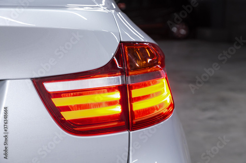 Glowing taillight of a modern car close-up.