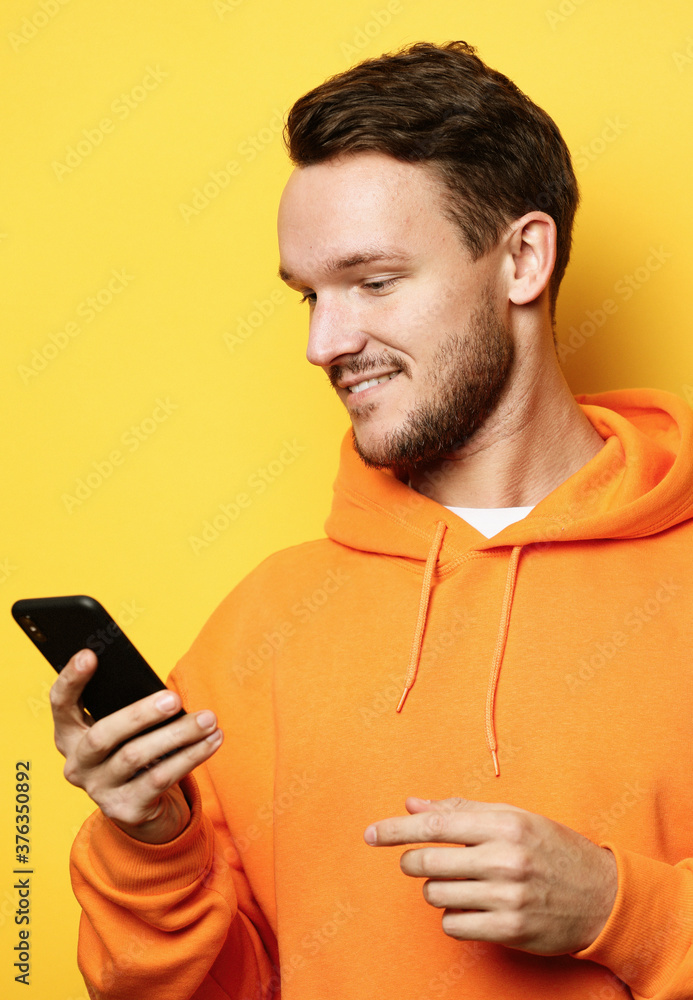 tehnology and people concept - young man with mobile phone, tallk with friends tehnology and people concept - young man with mobile phone, tallk with friends