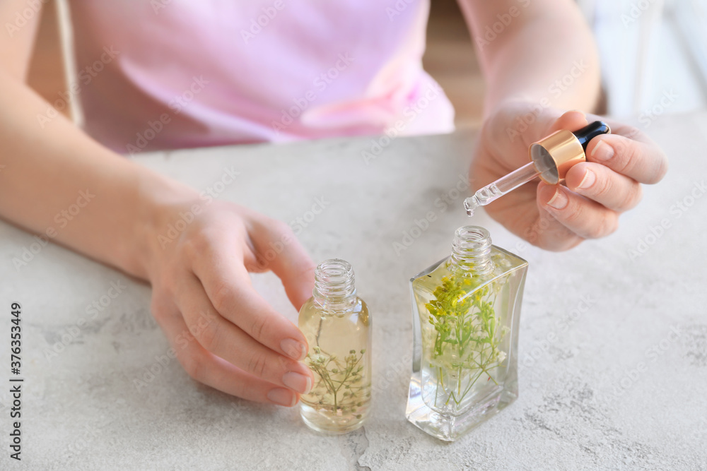 Fototapeta premium Woman making natural air freshener at table, closeup