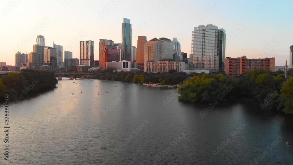 Cinematic shot of austin texas, with people enjoying the lake, and a bird flying majestically across the screen. Cinematic shot of austin texas, with people enjoying the lake, and a bird flying majestically across the screen.