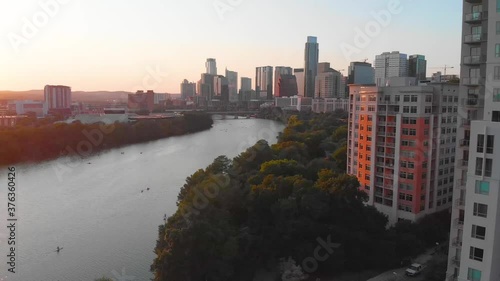View of downtown Austin Texas from the end of Rainey Street. Drone shot at sunset in August 2020