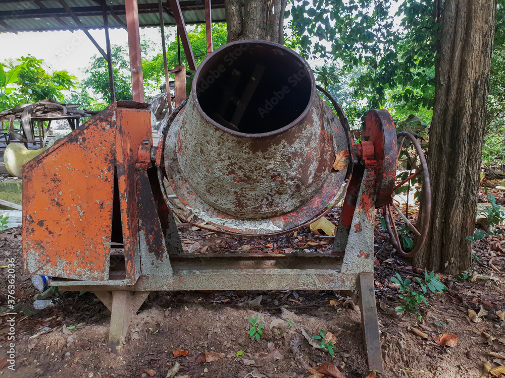 Old dirty Concrete mixer with sand and stones Old dirty Concrete mixer with sand and stones