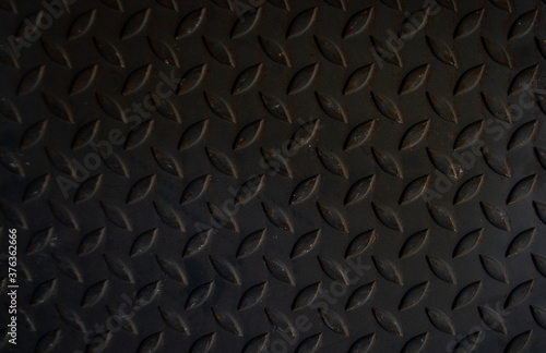 The old iron plate has a slightly rusted pattern.