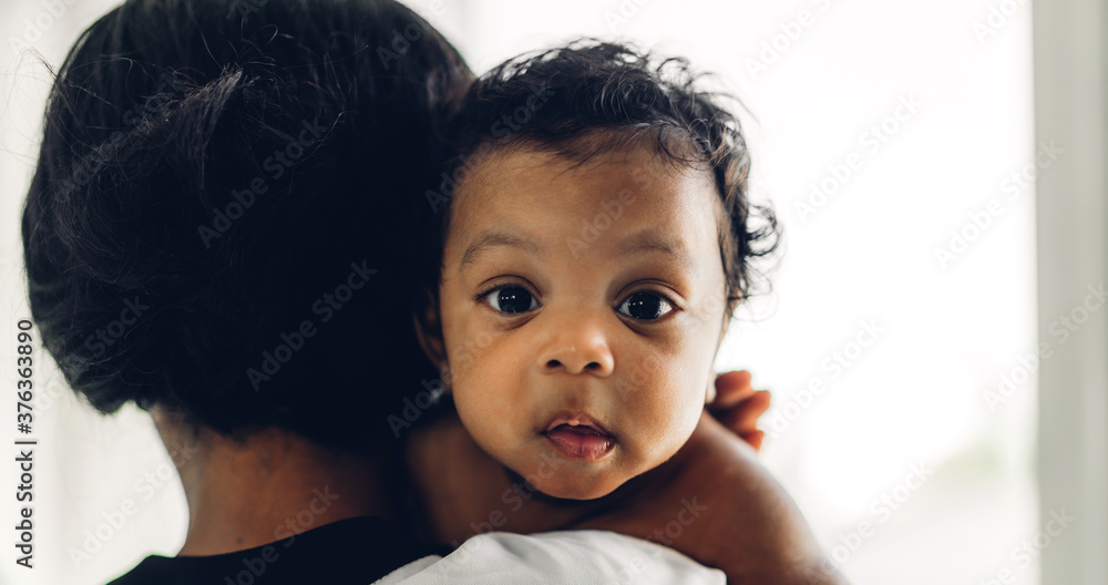 Portrait of enjoy happy love family african american mother playing with adorable little african american baby.Mom touching with cute son moments good time in a white bedroom.Love of black family Portrait of enjoy happy love family african american mother playing with adorable little african american baby.Mom touching with cute son moments good time in a white bedroom.Love of black family