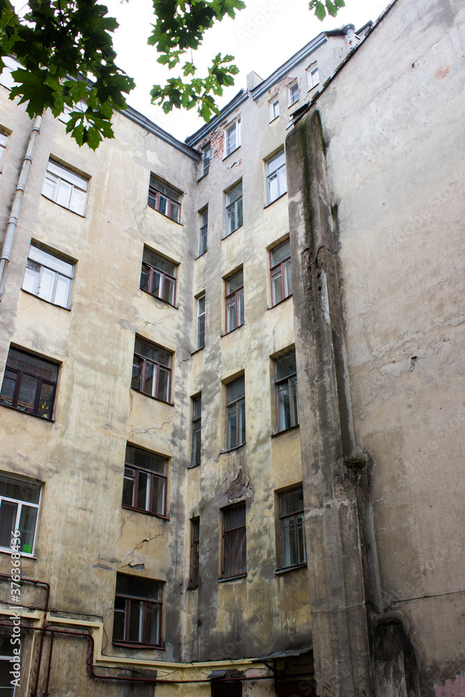 Old courtyard in St. Petersburg. Building's facade. Russian architecture