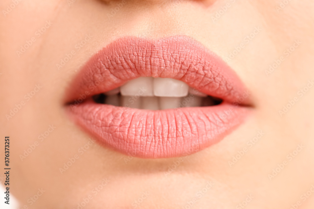 Fototapeta premium Beautiful young woman with pink lips, closeup