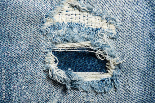 torn on blue jeans