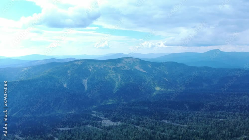 Aerial view from flying drone on mountain forest background and peak of blue mountain range. Aerial view from flying drone on mountain forest background and peak of blue mountain range.
