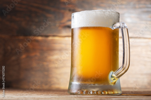 mug of beer on a wooden background