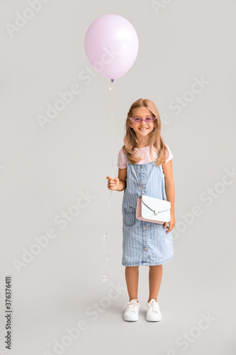 Little girl with balloon on...