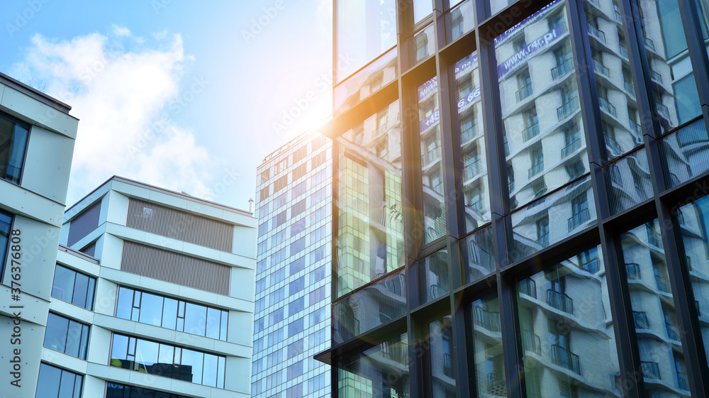 Office building, details of blue glass wall and sun reflections. Office building, details of blue glass wall and sun reflections.