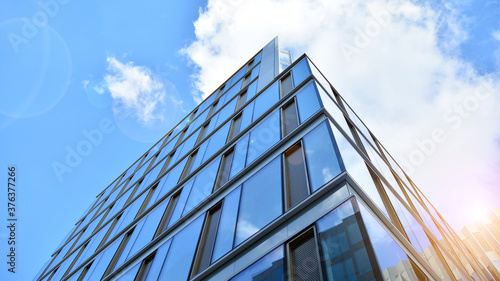 Office building, details of blue glass wall and sun reflections.