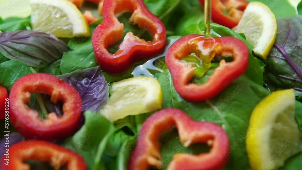 Pouring Virgin Olive Oil to Fresh Vegetable Salad. Mediterranean Kitchen Concept Pouring Virgin Olive Oil to Fresh Vegetable Salad. Mediterranean Kitchen Concept