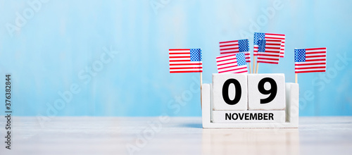 9 November of white Calendar with United States of America flag on wood background. Veterans day 2020 and Holiday concept photo