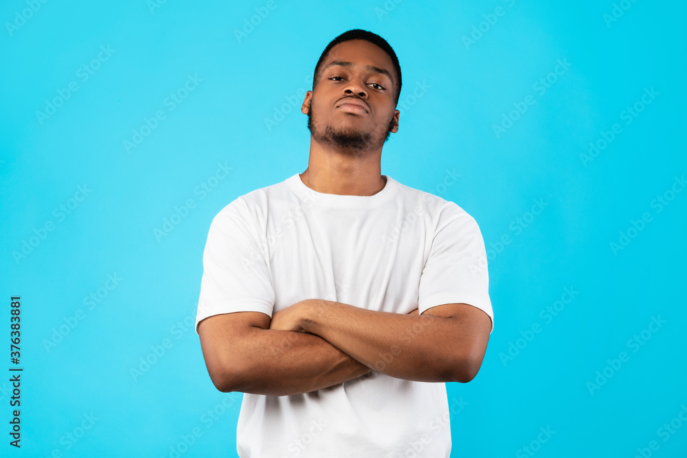 Cool Black Man Standing Crossing Hands Posing On Blue Background Cool Black Man Standing Crossing Hands Posing On Blue Background