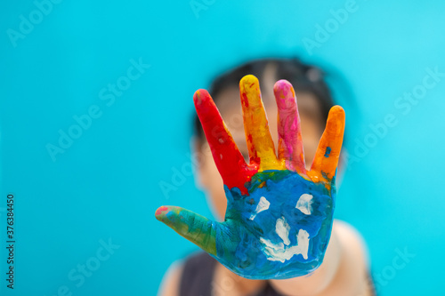 kid paint the water on the hand. Focus at baby hand.