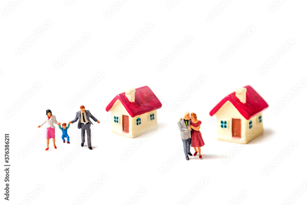 miniature couple with tiny home and piggy bank isolated on white background. miniature couple with tiny home and piggy bank isolated on white background.