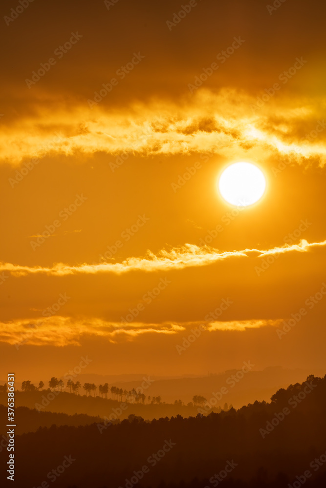 Orange sunset over the hills with cloudy sky Orange sunset over the hills with cloudy sky