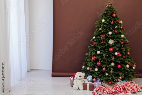 interior of the house with Christmas green Christmas tree decorations and gifts
