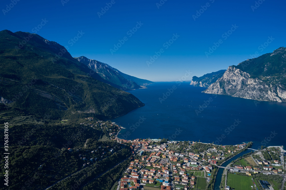 Perfect blue sky. Rock in the background the city of Riva del Garda, Italy. Alps Lake Garda and the city of Riva del Garda, Italy. Aerial view. Trentino Alto Adige region, Italy