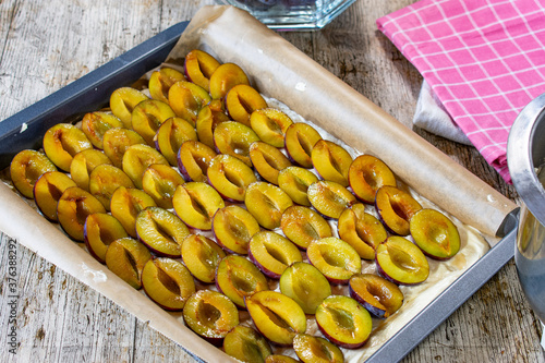 Bild auf Leinwand Raw plum cake on a baking sheet