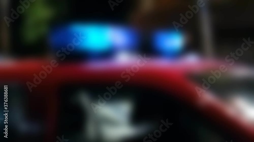defocused video of the sires of a police squad car outside photo