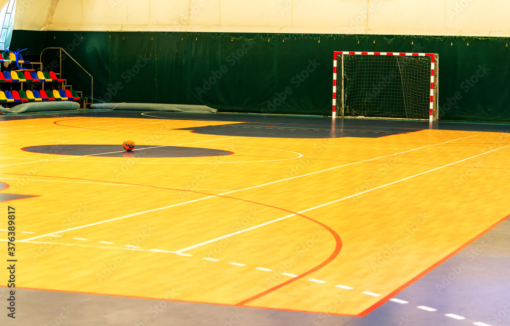 Gym for playing futsal, minifootball. Folded wooden parquet on the