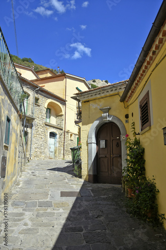 A small road crosses the old buildings of Catelmezzano  a rural village in the Basilicata region  Italy. 