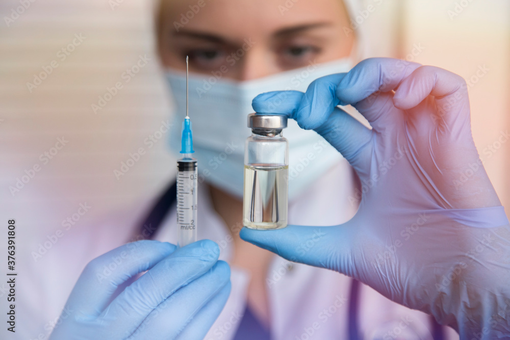 female doctor is holding syringe and vaccine for vaccination female doctor is holding syringe and vaccine for vaccination