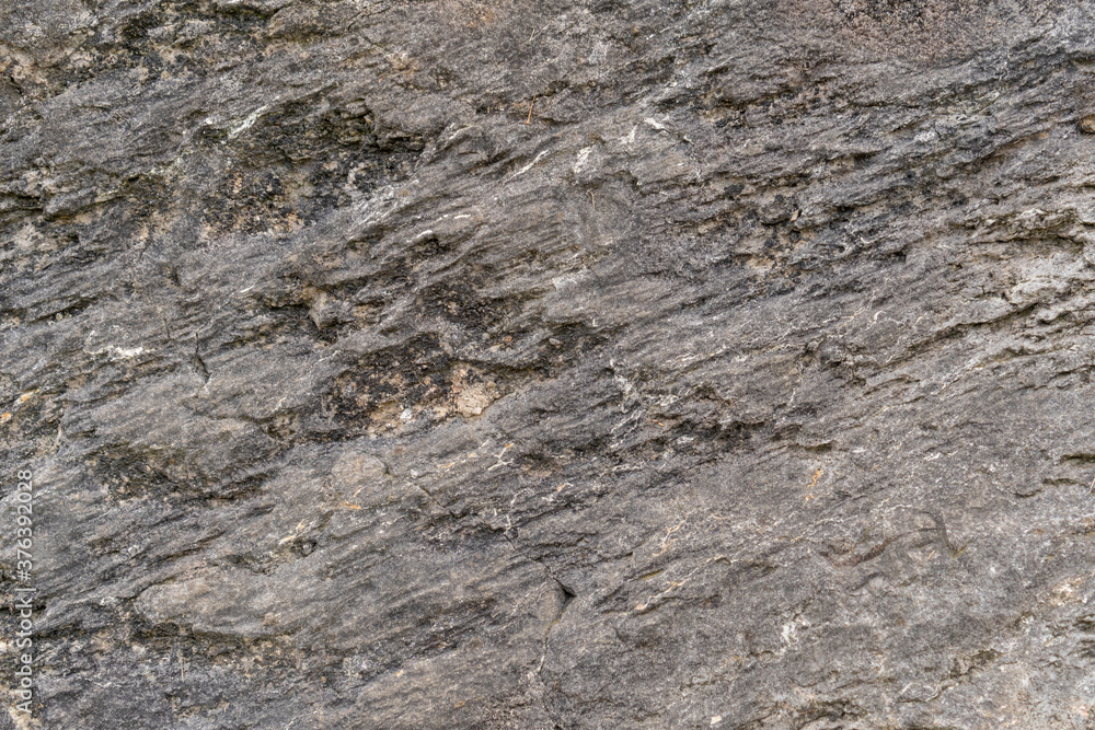 Grungy cracked stone texture from natural rock retro style. Weathered ancient wall background Grungy cracked stone texture from natural rock retro style. Weathered ancient wall background