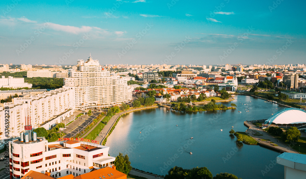Obraz premium Minsk, Belarus. Elevated View Of Minsk Skyline In Sunny Summer Evening. Nemiga District In Sunset Time. Aerial View Of Cityscape Of Belarusian Capital. Panorama Panoramic View