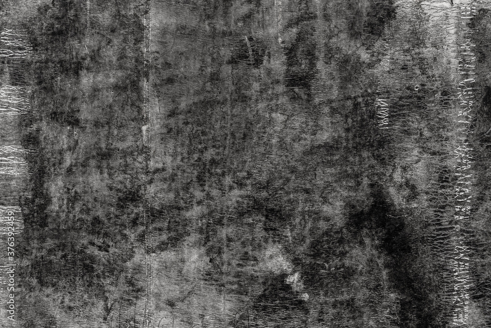 Fototapeta premium Black texture of old roofing material. Weathered mottled shabby building material with cracks