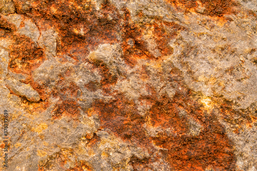 Grungy bright stone close up, rusty stone wall corrosion texture Grungy bright stone close up, rusty stone wall corrosion texture