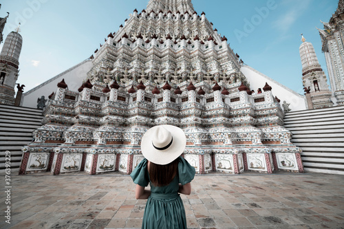 Young Asian woman is enjoy sightseeing and traveling at Wat Arun temple in Bangkok, Thailand. photo