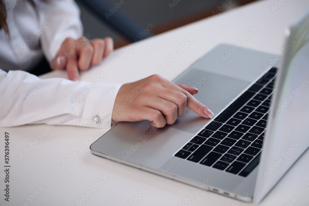 Woman sitting at desk and working at computer hands close up Woman sitting at desk and working at computer hands close up